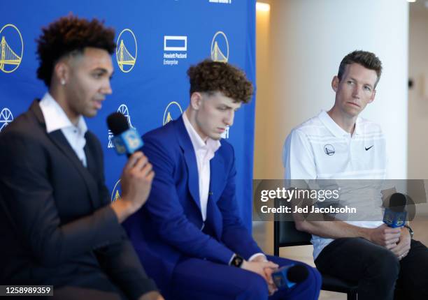 General manager Mike Dunleavy Jr. Of the Golden State Warriors, right, listens with Trayce Jackson-Davis, left and Brandin Podziemski, center, during...