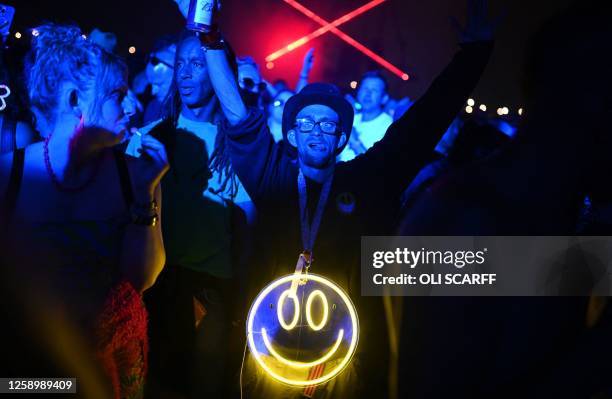 Festivalgoers listen to British duo The Chemical Brothers perform their DJ set in the Arcadia area on day 3 of the Glastonbury festival in the...