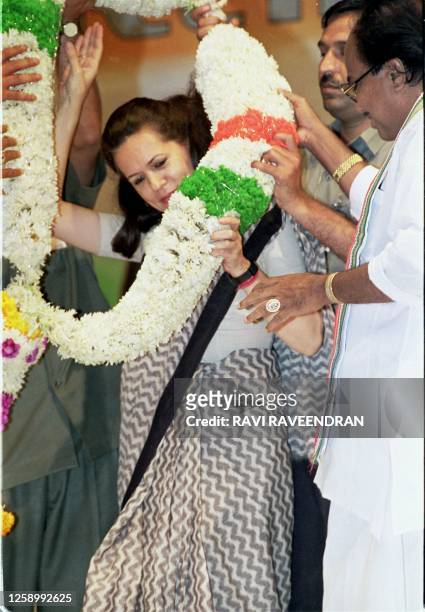 Congress Party members garland Sonia Gandhi, widow of former Indian premier Rajiv Gandhi in New Delhi 06 April after she is endorsed as leader of...