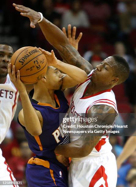 Houston Rockets guard Isaiah Canaan applies defensive pressure on Phoenix Suns guard Tyler Ennis during the second half of an NBA basketball game at...