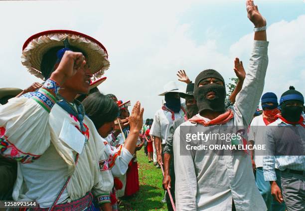 Delegation of the Zapatista National Liberaton Army are greeted by a group of Huicholes, indigenous Mexican Indians, during the inauguration of the...