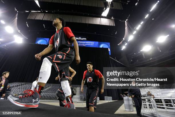 Utah guard Isaiah Wright, left, and Utah forward Chris Reyes walk onto the court during practice for the NCAA South Regional at NRG Stadium on...