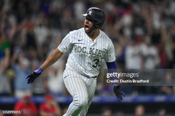 Elias Diaz of the Colorado Rockies celebrates after hitting an eighth inning grand slam homerun in a game against the Los Angeles Angels at Coors...