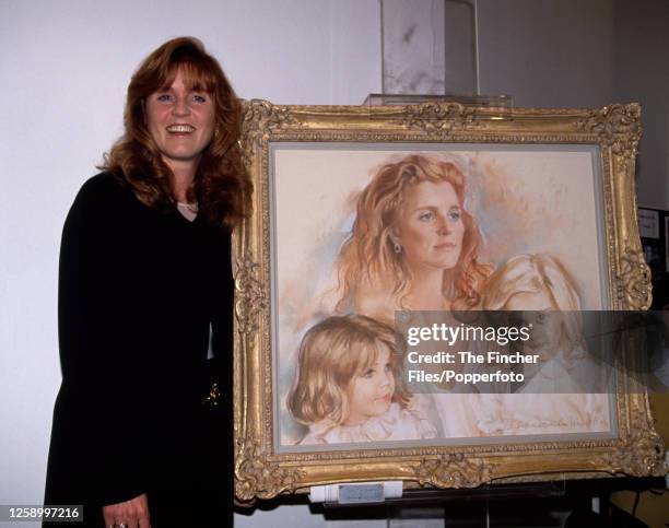 Sarah The Duchess of York with a portrait of her and her two daughters, Princess Eugenie and Princess Beatrice, by the artist Barbara Kaczmarowska...