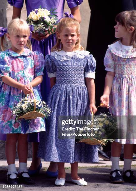 Princess Beatrice holding a flower basket as a bridesmaid at a wedding in Marlow on 6th August 1994.