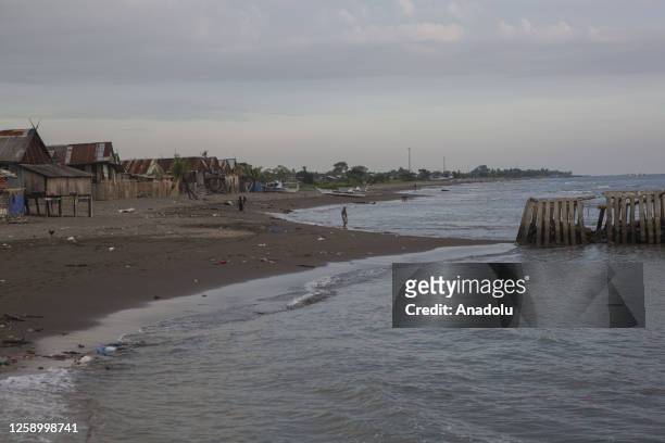 Childrean playing near the sea wall at a village affected by rising sea level in Galesong, Takalar Regency, Indonesia, on June 20. Coastal abrasion...