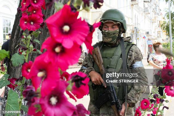 Member of Wagner group stands guard in a street in the city of Rostov-on-Don, on June 24, 2023. President Vladimir Putin on June 24, 2023 said an...