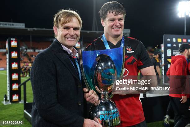 Crusaders' Scott Barrett and coach Scott Robertson celebrate with the Super Rugby Pacific trophy after the Super Rugby Pacific final match between...