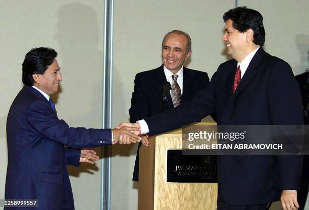 Peruvian presidential candidates Alejandro Toledo of the Peru Posible party and Alan Garcia of the Apra party shake hands prior to a presidential...