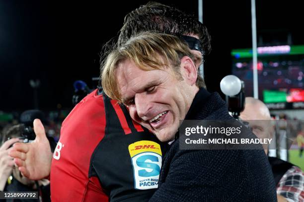 Crusaders head coach Scott Robertson gives a hug to Scott Barrett after winning the Super Rugby Pacific final match between the Chiefs and Crusaders...