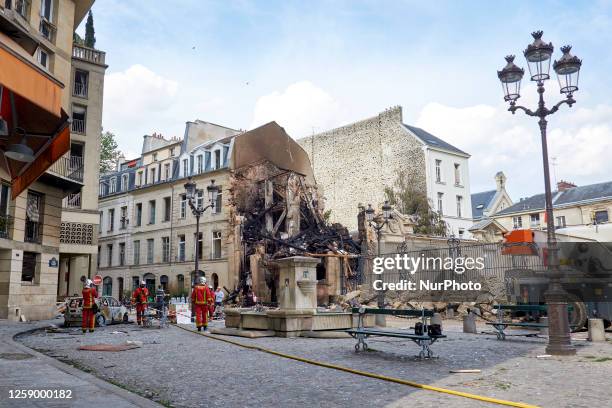 Firemen working on destruction and rubble in the aftermath of an explosion in a building on Rue Saint-Jacques near Place Alphonse-Laveran in the 5th...