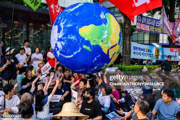 Activists gather to protest against a planned release of water from the Fukushima Dai-Ichi nuclear plant in Japan, in Seoul on June 24, 2023.