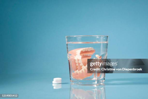 cleaning dentures in water pills - dentures stock pictures, royalty-free photos & images