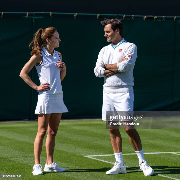 In this handout images released by Kensington Palace on June 24 Catherine, Princess of Wales and Wimbledon Champion Roger Federer talk before playing...