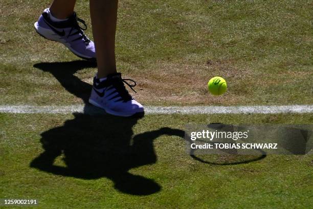 The shadow of Czech Republic's Petra Kvitova is seen on the grass court as she serves the ball to France's Caroline Garcia during the women's singles...