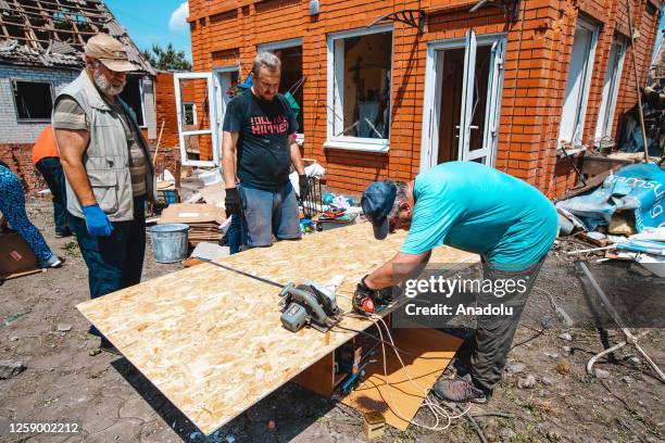 People work in a building damaged by a Russian cruise missile attack in Dnipro, Ukraine on June 24, 2023. Russian missiles hit a residential building...