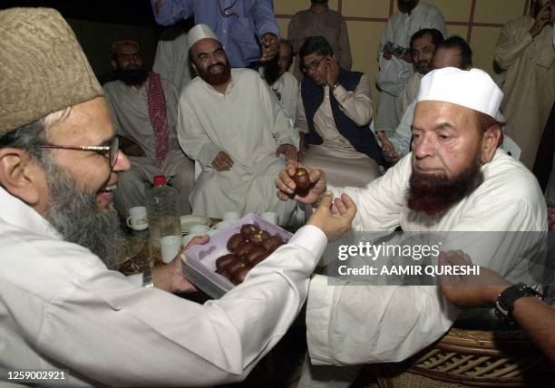 Munawar Hassan , a central leader of Muttahida Majlis-e-Amal , an electoral alliance of six Islamic parties of Pakistan, offer sweet to alliance...