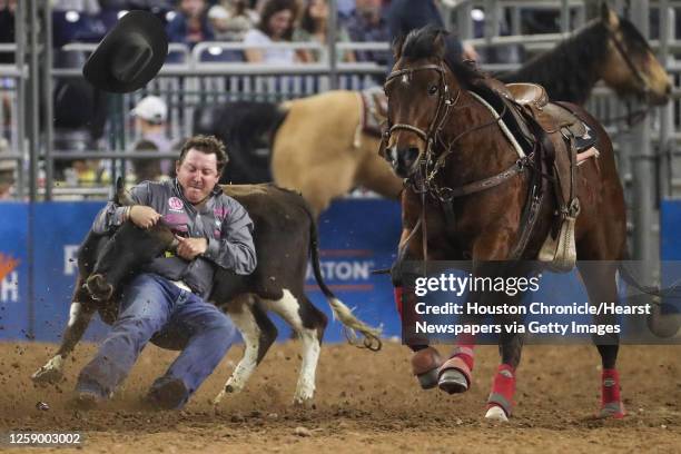 Dylan Schroeder dives off his horse to pull down his steer in 4.3 seconds in steer wrestling during Super Series V, round 3, at RodeoHouston Tuesday,...