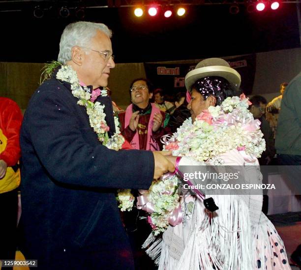 Bolivian presidential candidate Gonzalo Sanchez de Lozada , Liberal former president, dances with an unidentified aymara indian during the closing...