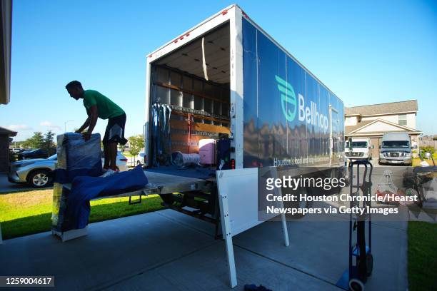 Jonathan Nieves loads a Bellhop truck while packing and loading up a household for a move Thursday, July 28, 2022 in Tomball.
