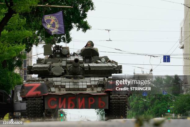 Members of Wagner group sit atop of a tank in a street in the city of Rostov-on-Don, on June 24, 2023. President Vladimir Putin on June 24, 2023 said...