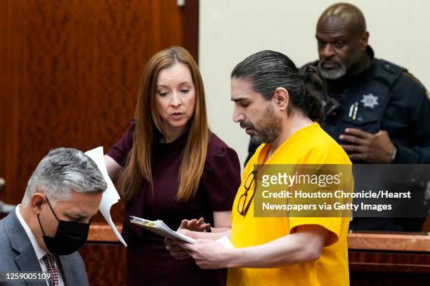 Robert Solis works with his lawyer Mandy Miller as he appears in court to consider representing himself or get new counsel in the capital murder of a...