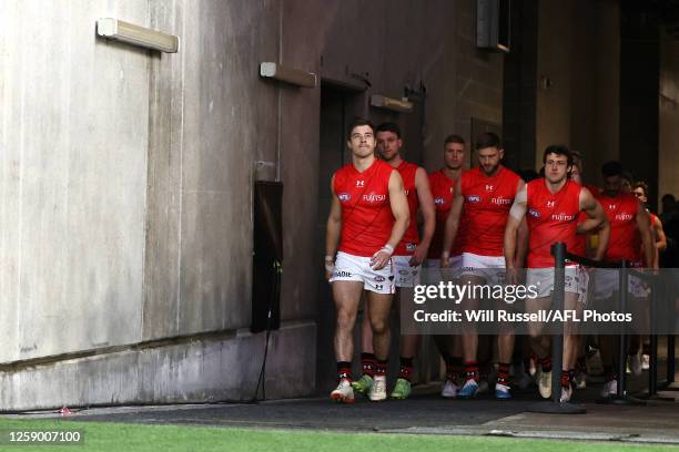 Zach Merrett of the Bombers leads the team out onto the field during the 2023 AFL Round 15 match between the Fremantle Dockers and the Essendon...