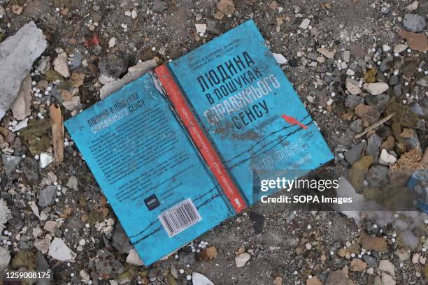 Book scattered among the debris near a residential building damaged by Russian missile strikes in Kyiv. Destroyed apartments of a residential...