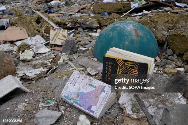 Books are scattered among the debris near a residential building damaged by Russian missile strikes in Kyiv. Destroyed apartments of a residential...