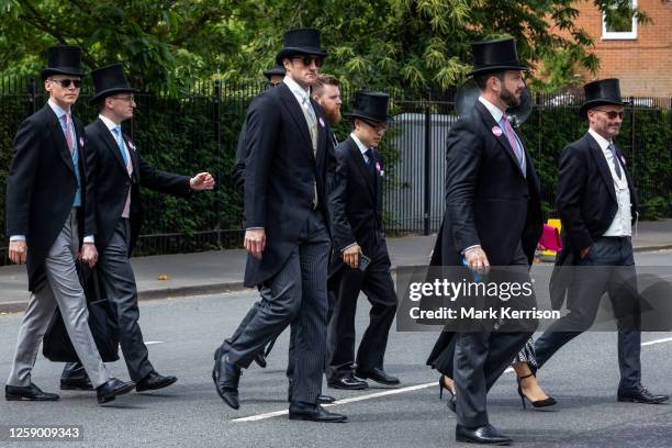 Racegoers wearing morning dress arrive for the fifth day of Royal Ascot on 24 June 2023 in Ascot, United Kingdom. Each Royal Ascot enclosure has a...