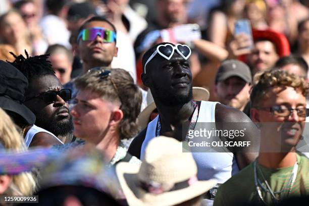 British rapper Stormzy watches fellow British rapper Aitch performing on the Pyramid Stage on day 4 of the Glastonbury festival in the village of...