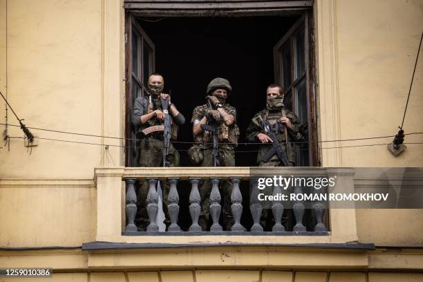 Members of Wagner group stand on the balcony of the circus building in the city of Rostov-on-Don, on June 24, 2023. President Vladimir Putin on June...