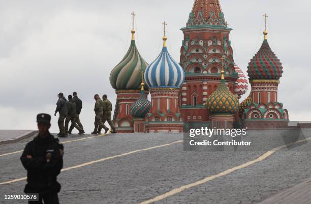 Russian Police officer guards the Red Square near the Kremlin on June 24, 2023 in Moscow, Russia. Fighters of the Wagner Group on tanks, trucks and...