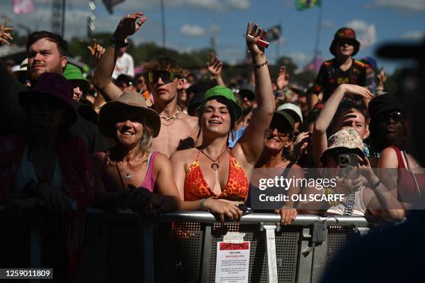 Festivalgoers wait in the crowd by the Pyramid Stage on day 4 of the Glastonbury festival in the village of Pilton in Somerset, southwest England, on...