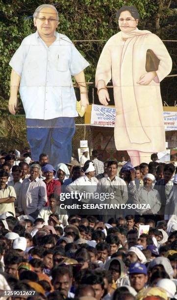 Supporters stand in front of cutouts of Bahujan Samaj Party leader Kanshiram and Uttar Pradesh Chief Minister Mayawati at a rally in Bombay 15 March...