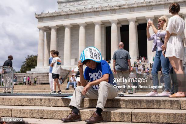 An anti-abortion activist shades himself during a Celebrate Life Day Rally at the Lincoln Memorial on June 24, 2023 in Washington, DC. The rally,...