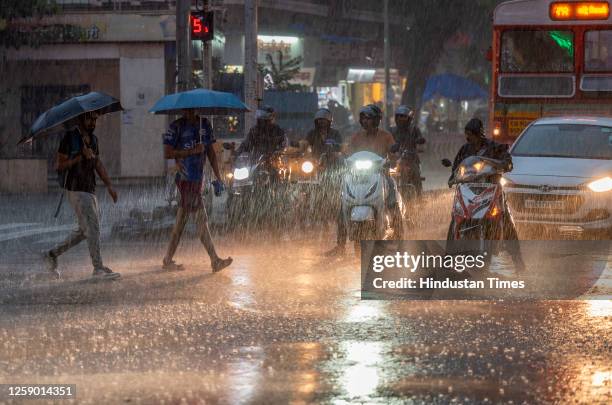 People going through the heavy rain at Parel, on June 24, 2023 in Mumbai, India.