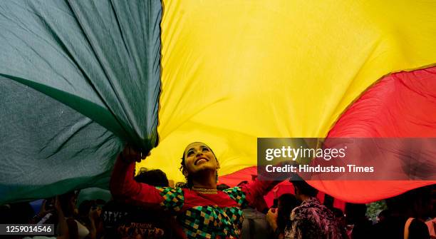 Members of LGBTQ community dances during a pride parade celebrating lesbian, gay, bisexual, transgender, and queer social and self-acceptance,...