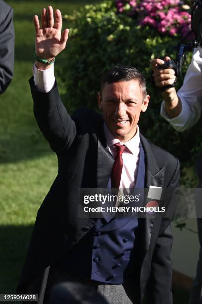 Jockey Frankie Dettori waves to the crowds after riding his last Royal Ascot race on the final day of the Royal Ascot horse racing meeting in Ascot,...