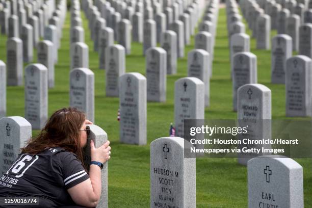 Elizabeth Thomas visits the grave of her husband, Army Staff Sgt. David Thomas, a veteran of Iraq and Afghanistan, as she honors him on Memorial Day...