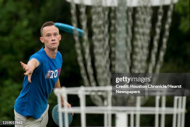 Shea Cain takes a shot while playing a round of disc golf during the Thursday night league of the Houston Flying Disc Society on Thursday, Sept. 3,...