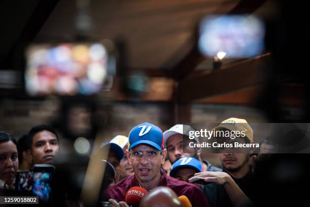 Opposition leader Henrique Capriles addresses the media after signing his presidential candidacy application at the national primary commission on...