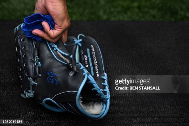 St. Louis Cardinals pitcher Miles Mikolas picks up his glove during the practise prior to the first of the two-game, 2023 major league baseball...