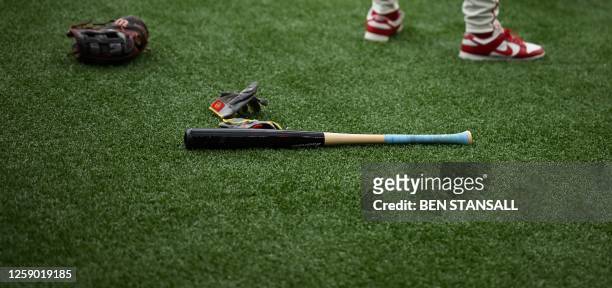 St. Louis Cardinals' bats and gloves are pictured on the pitch prior to the first of the two-game, 2023 major league baseball London Series between...
