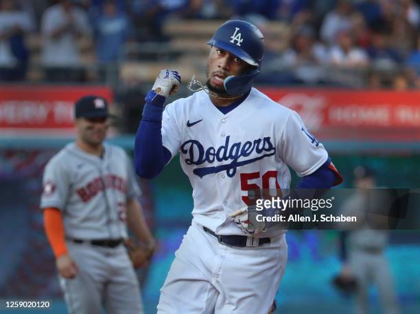 Los Angeles, CA Dodgers Mookie Betts pumps his fist as he rounds the bases after hitting a home run in the first inning against the Astros at Dodger...