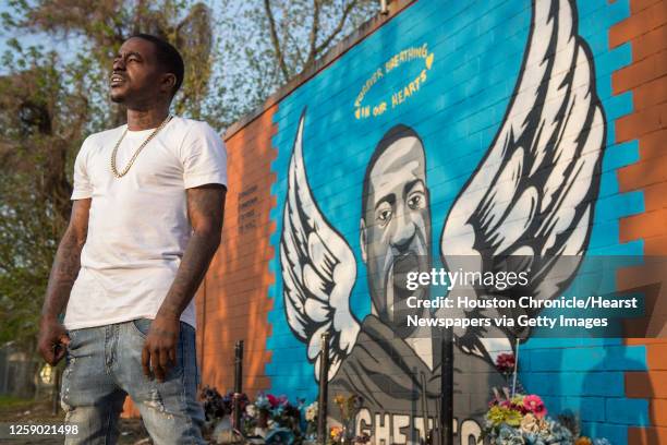 Rap artist Cal Wayne poses for a portrait at the George Floyd memorial mural in 3rd Ward Friday, March 26, 2021 in Houston. Wayne said he expects to...