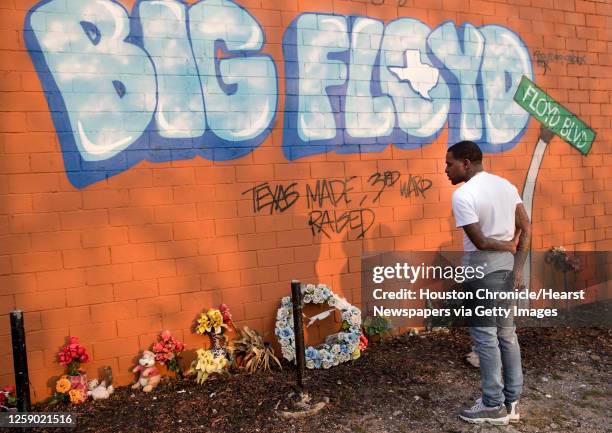 Rap artist Cal Wayne pauses at the George Floyd memorial mural in 3rd Ward Friday, March 26, 2021 in Houston. Wayne said he expects to be in...