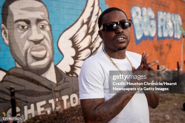 Rap artist Cal Wayne poses for a portrait at the George Floyd memorial mural in 3rd Ward Friday, March 26, 2021 in Houston. Wayne said he expects to...