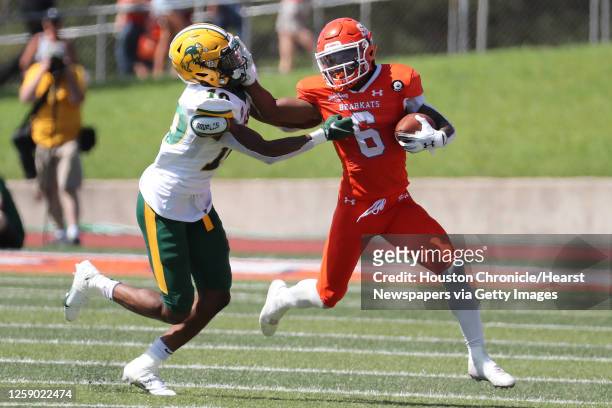 Sam Houston State running back Noah Smith battles with North Dakota State safety Dom Jones for extra yardage as he runs around the end during the...