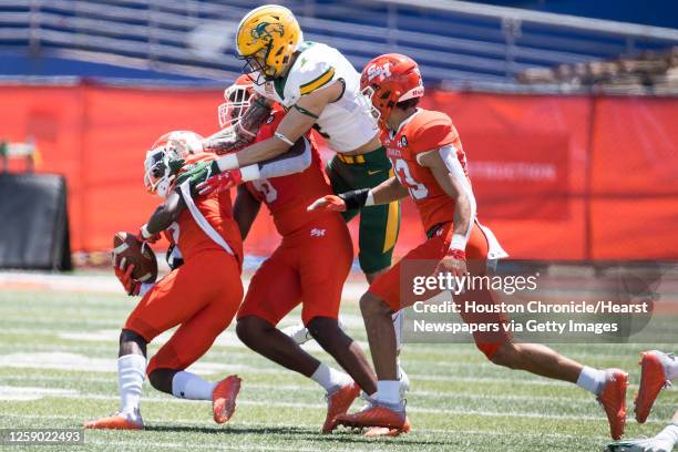 Sam Houston State defensive back Jaylen Thomas comes down with a loose ball, taking it away from North Dakota State wide receiver Christian Watson ,...